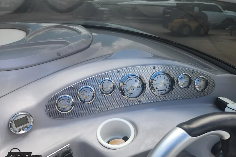 Slide: The Image of Dashboard of a 2005 Baja 242 Islander boat with multiple gauges and controls. - 30