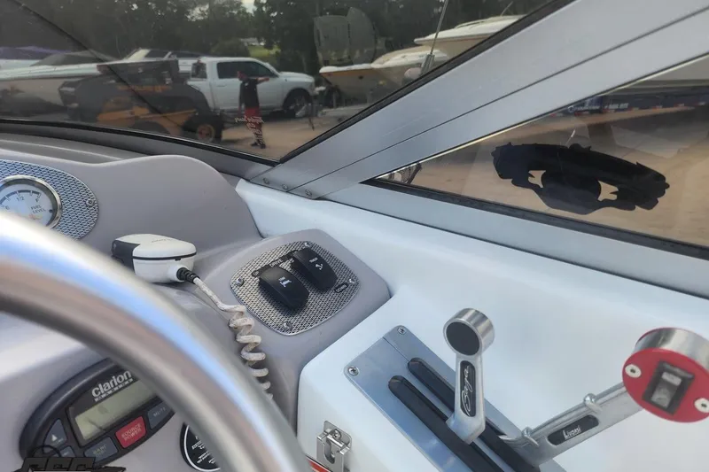 Slide: The Image of 2005 Baja 242 Islander boat dashboard with controls and gauges. - 31