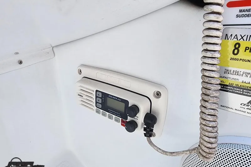 Slide: The Image of 2005 Baja 242 Islander boat radio and capacity label detail. - 32