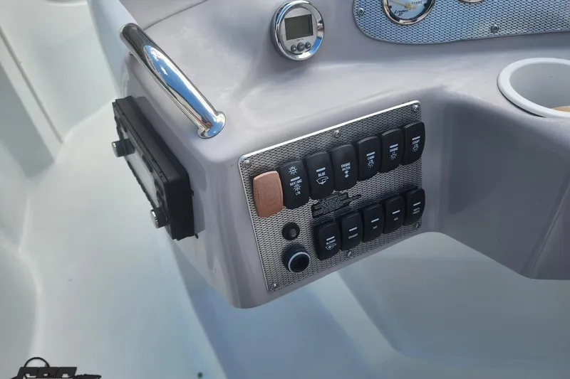 Slide: The Image of Control panel of a 2005 Baja 242 Islander boat with switches and gauges. - 34