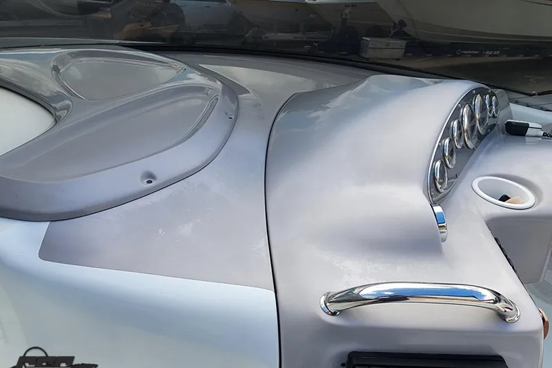 Slide: The Image of 2005 Baja 242 Islander dashboard with gauges and cup holder, featuring sleek design. - 35