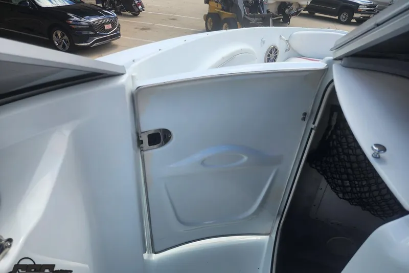 Slide: The Image of 2005 Baja 242 Islander boat interior with open cabin door and visible seating area. - 38