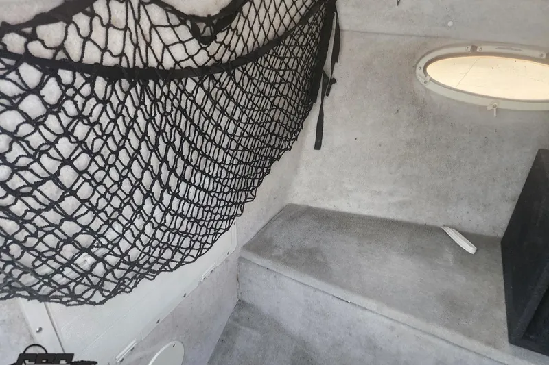 Slide: The Image of Interior of a 2005 Baja 242 Islander boat with storage netting and porthole. - 41