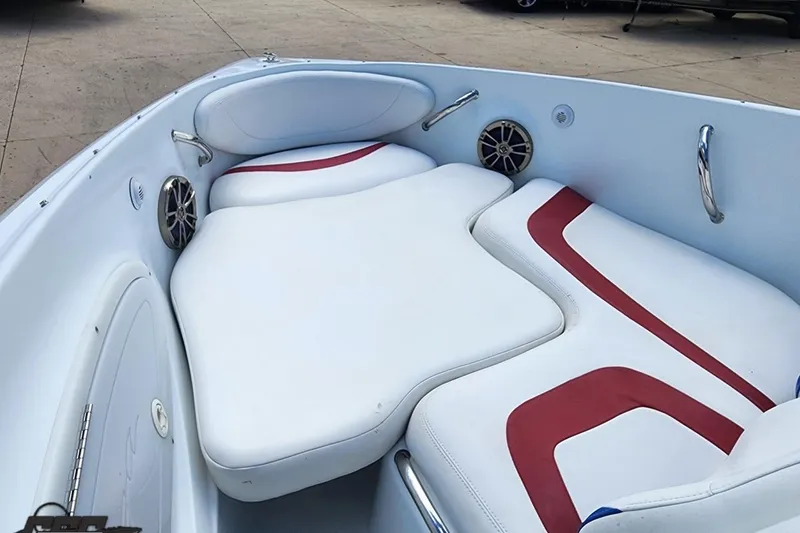 Slide: The Image of 2005 Baja 242 Islander boat interior with white and red cushioned seating. - 42