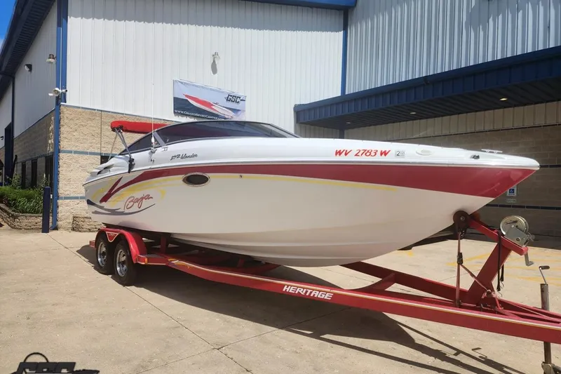 Slide: The Image of 2005 Baja 242 Islander boat on red trailer outside a building. - 5