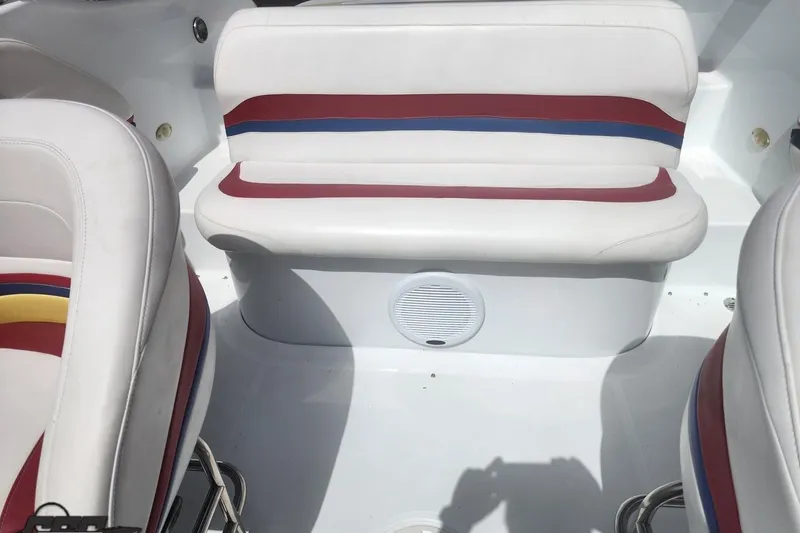 Slide: The Image of 2005 Baja 242 Islander boat interior with white, red, and blue seating. - 53