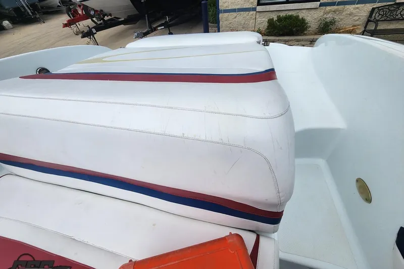 Slide: The Image of 2005 Baja 242 Islander boat interior with white and striped seating. - 55