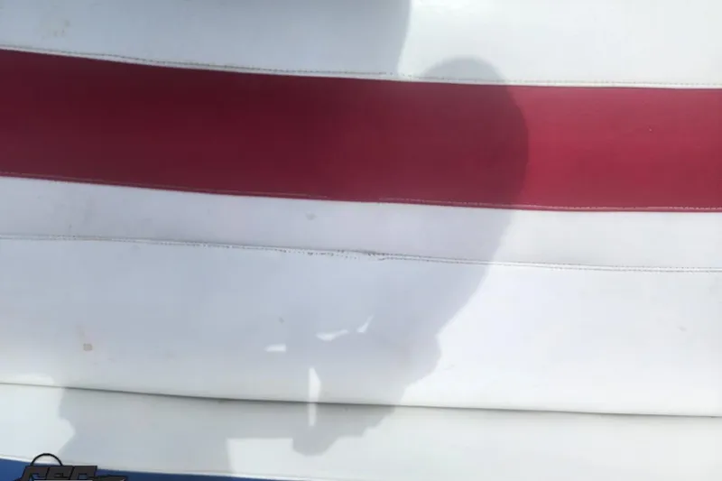 Slide: The Image of 2005 Baja 242 Islander boat seat with red and white upholstery. - 57