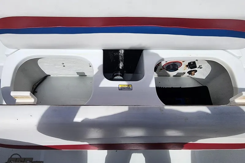 Slide: The Image of 2005 Baja 242 Islander boat interior compartments with red and blue trim. - 58