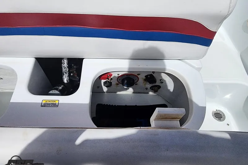 Slide: The Image of 2005 Baja 242 Islander boat interior with control panel and seating. - 59