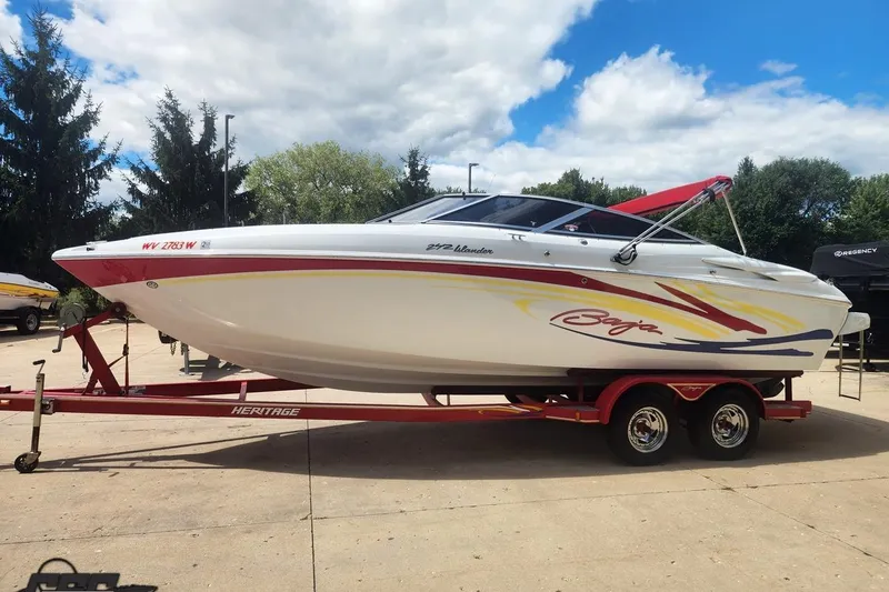 Slide: The Image of 2005 Baja 242 Islander boat on trailer, vibrant graphics, parked outdoors. - 8