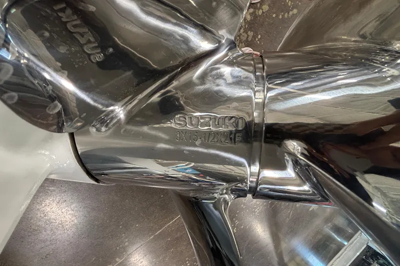 Slide: The Image of Close-up of a shiny Suzuki propeller on a 2026 JC Sporttoon 26TT. - 6