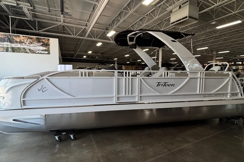 The Image of 2026 JC Sporttoon 26TT pontoon boat displayed in a showroom. - 1