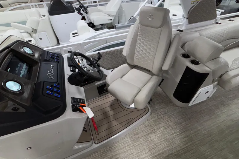 Slide: The Image of 2026 JC Sporttoon 26TT boat interior with modern helm and luxurious seating. - 16
