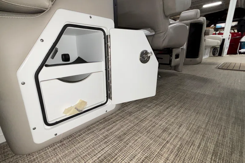 Slide: The Image of Open storage compartment in 2026 JC Sporttoon 26TT boat interior. - 21