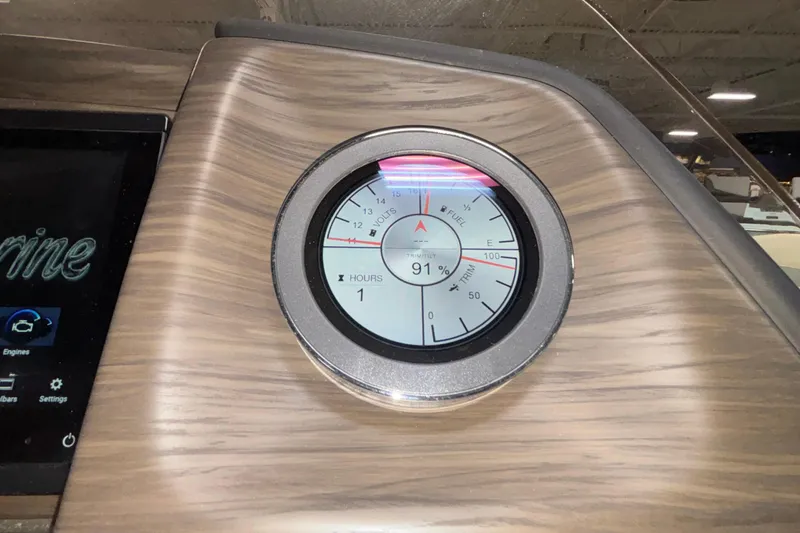 Slide: The Image of Dashboard gauge of 2026 JC Sporttoon 26TT, displaying fuel, volts, and trim tilt. - 34