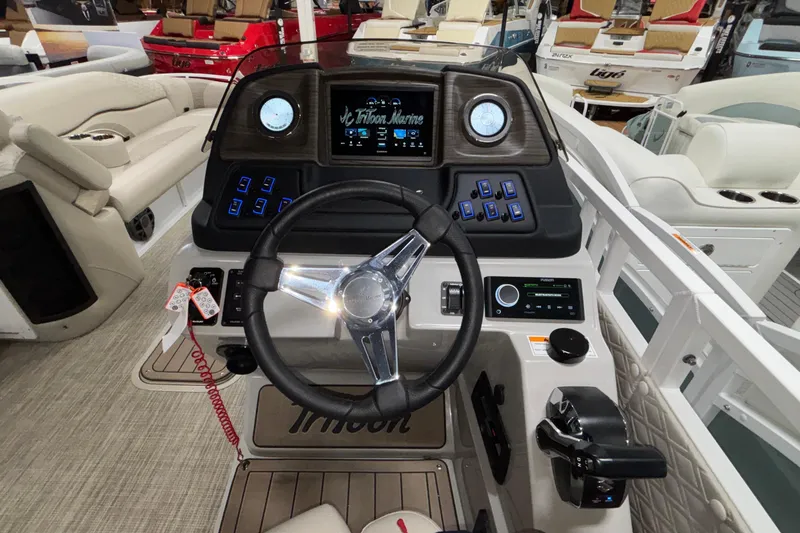 Slide: The Image of Cockpit of 2026 JC Sporttoon 26TT boat with modern controls and steering wheel. - 35