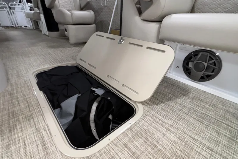 Slide: The Image of Open storage compartment in 2026 JC Sporttoon 26TT boat interior with speaker. - 39