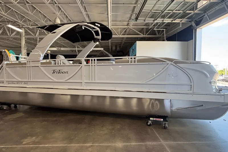 Slide: The Image of 2026 JC Sporttoon 26TT pontoon boat in showroom, featuring sleek design and modern amenities. - 4