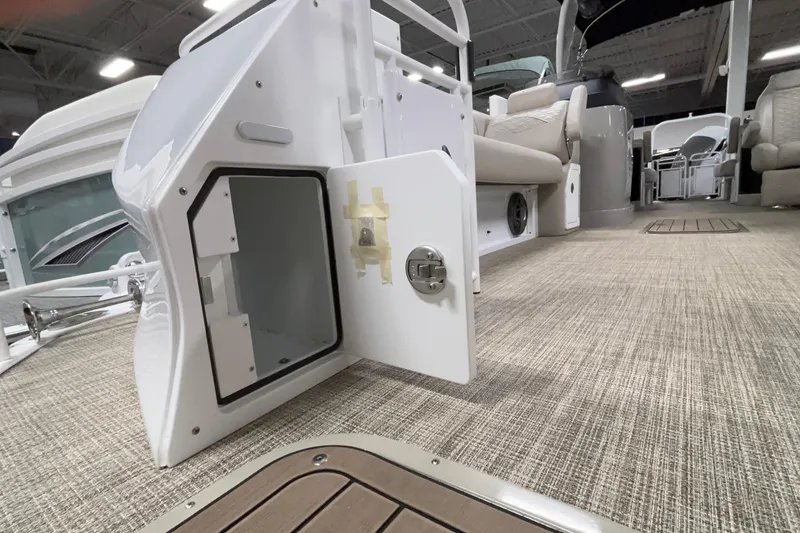 Slide: The Image of 2026 JC Sporttoon 26TT boat interior with open storage compartment and seating. - 42