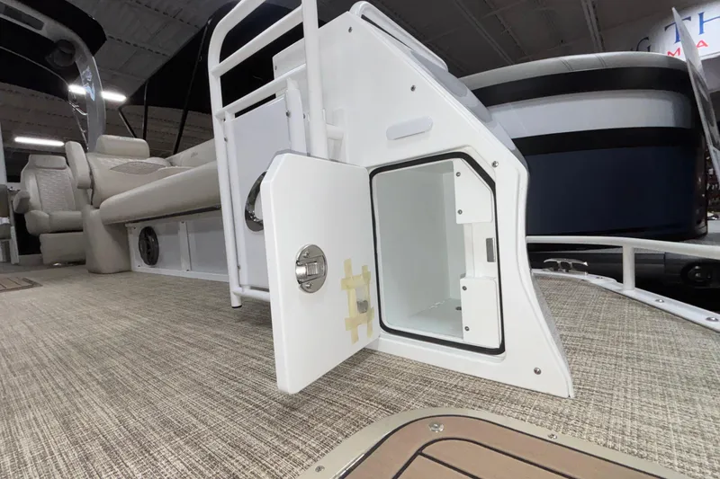 Slide: The Image of 2026 JC Sporttoon 26TT boat interior with open storage compartment and seating. - 43