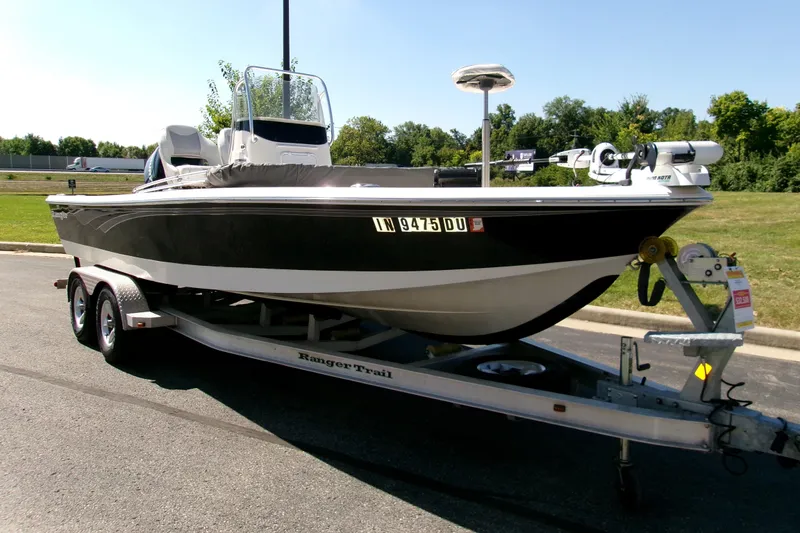Slide: The Image of 2015 Ranger 220 Bahia boat on trailer in parking lot, sunny day. - 2