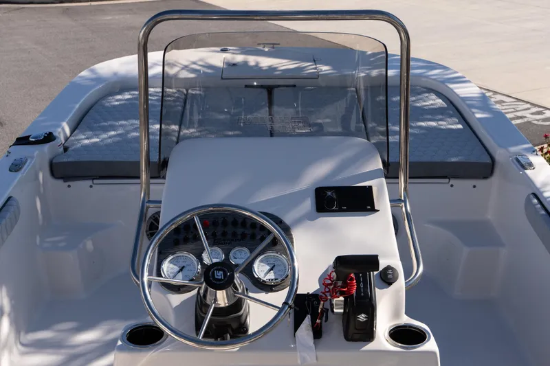 Slide: The Image of 2026 Carolina Skiff 21 LS boat dashboard with steering wheel and controls. - 11
