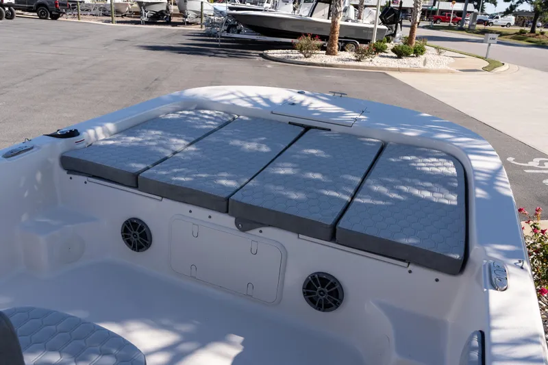 Slide: The Image of 2026 Carolina Skiff 21 LS boat interior with cushioned seating and speakers. - 16