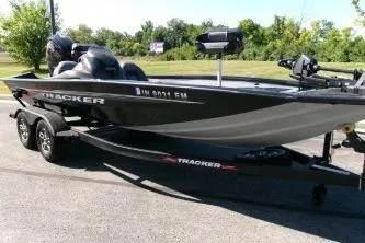 The Image of 2024 Tracker Pro Team 195 Tournament Edition boat on trailer, parked outdoors. - 1