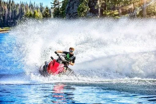 Slide: The Image of 2025 Kawasaki Jetski STX 160LX speeding on a lake, creating a large splash. - 1