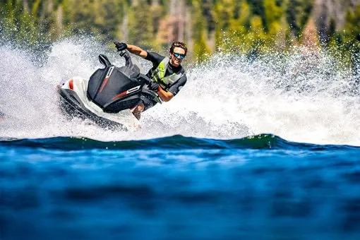 Slide: The Image of 2025 Kawasaki JET SKI STX 160X speeding on water with rider in action. - 4