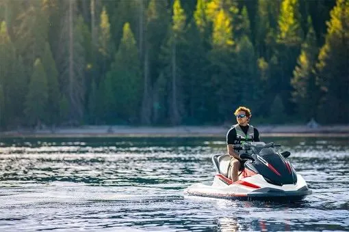 Slide: The Image of 2025 Kawasaki JET SKI STX 160X on a serene lake with forest backdrop. - 5