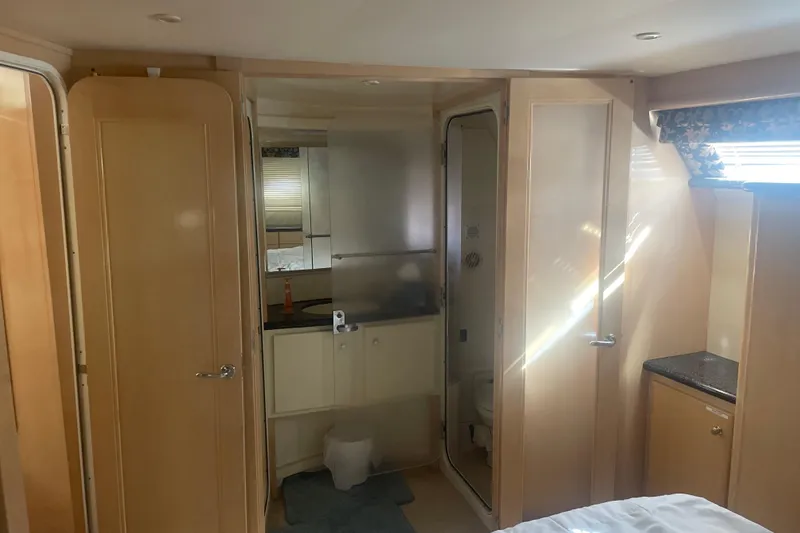 Slide: The Image of Interior of 2000 Carver 456 Aft Cabin Motor Yacht, featuring bathroom and wooden cabinetry. - 10