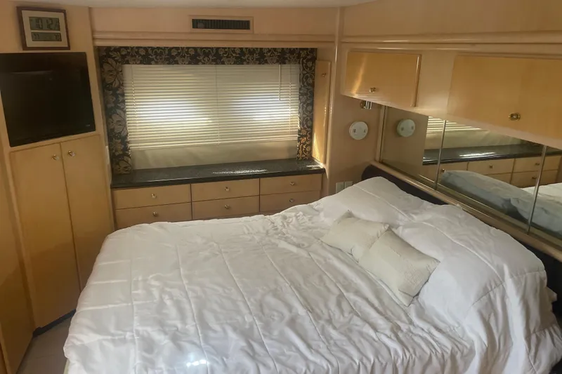 Slide: The Image of Interior of 2000 Carver 456 Aft Cabin Motor Yacht bedroom with bed and storage. - 11