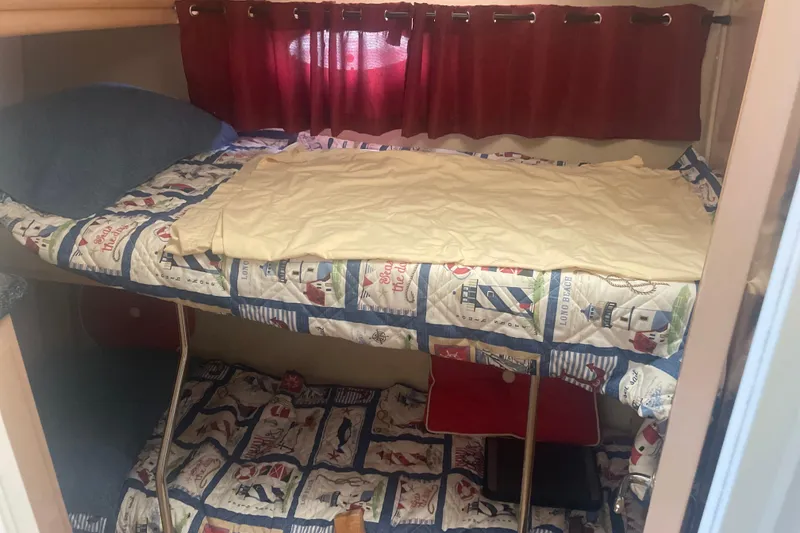 Slide: The Image of Bunk beds in 2000 Carver 456 Aft Cabin Motor Yacht with nautical-themed bedding. - 13