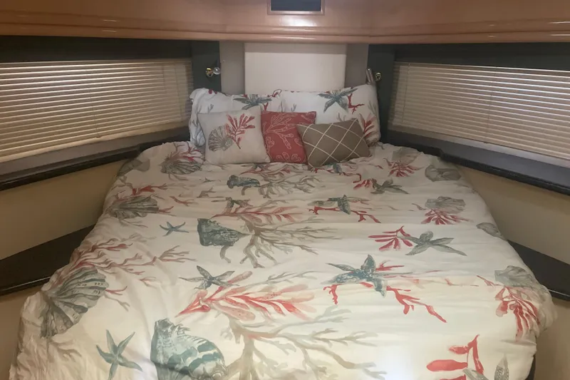 Slide: The Image of Cozy bedroom in 2000 Carver 456 Aft Cabin Motor Yacht with nautical-themed bedding. - 14