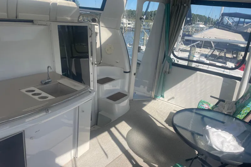 Slide: The Image of Interior of 2000 Carver 456 Aft Cabin Motor Yacht with kitchenette and seating area. - 4