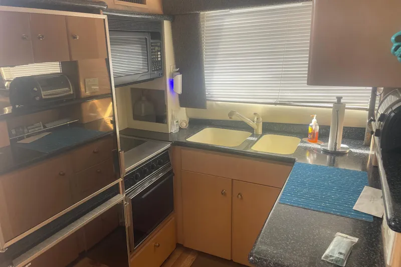 Slide: The Image of Kitchen area of 2000 Carver 456 Aft Cabin Motor Yacht with modern appliances. - 9