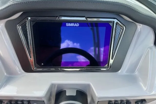 Slide: The Image of Dashboard of 2026 Chaparral 21 SSi boat featuring a Simrad display. - 12