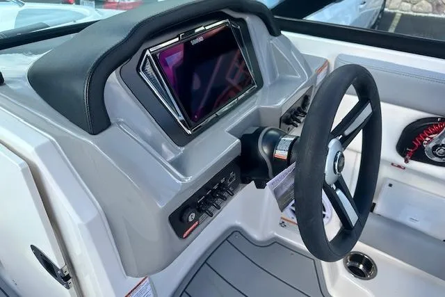 Slide: The Image of 2026 Chaparral 21 SSi boat dashboard with steering wheel and control panel. - 13