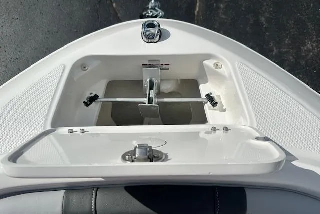 Slide: The Image of Bow storage compartment of 2026 Chaparral 21 SSi boat, featuring anchor and latch. - 21