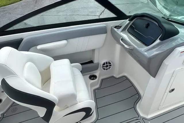 Slide: The Image of 2026 Chaparral 21 SSi boat interior with white seating and modern dashboard design. - 24