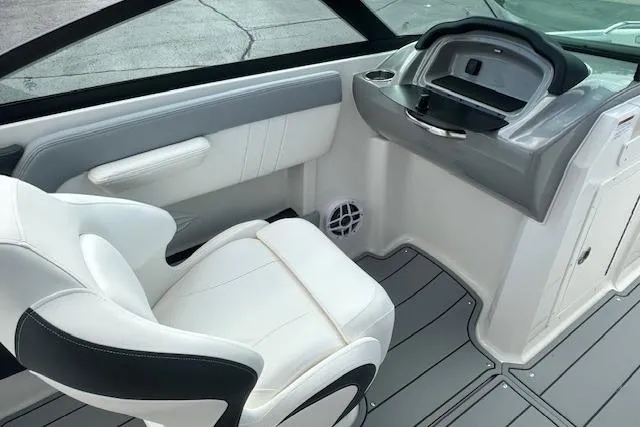 Slide: The Image of 2026 Chaparral 21 SSi boat interior with white seating and modern dashboard. - 25