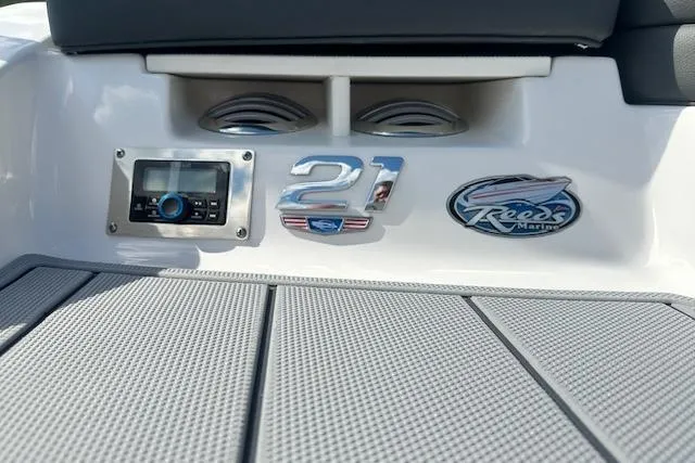 Slide: The Image of 2026 Chaparral 21 SSi boat dashboard with stereo system and branding logos. - 4