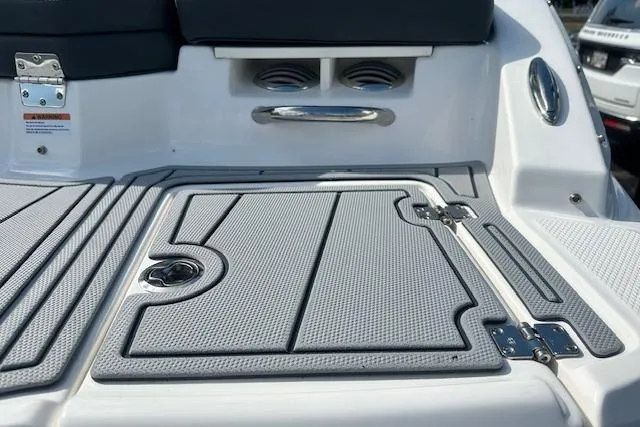 Slide: The Image of 2026 Chaparral 21 SSi boat deck with textured surface and storage compartment. - 5