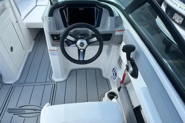 Slide: The Image of Interior view of 2026 Chaparral 21 SSi boat cockpit with steering wheel and controls. - 8