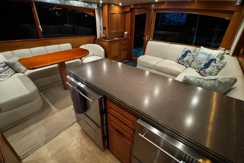 Slide: The Image of Luxurious interior of 2002 Cavileer 48 Flybridge Sportfish with modern kitchen and cozy seating. - 10
