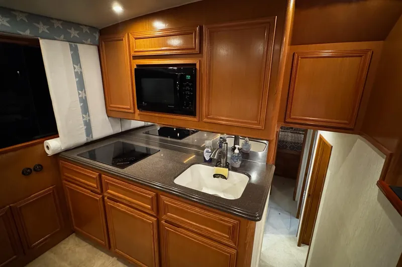 Slide: The Image of Luxurious kitchen interior of 2002 Cavileer 48 Flybridge Sportfish yacht. - 11
