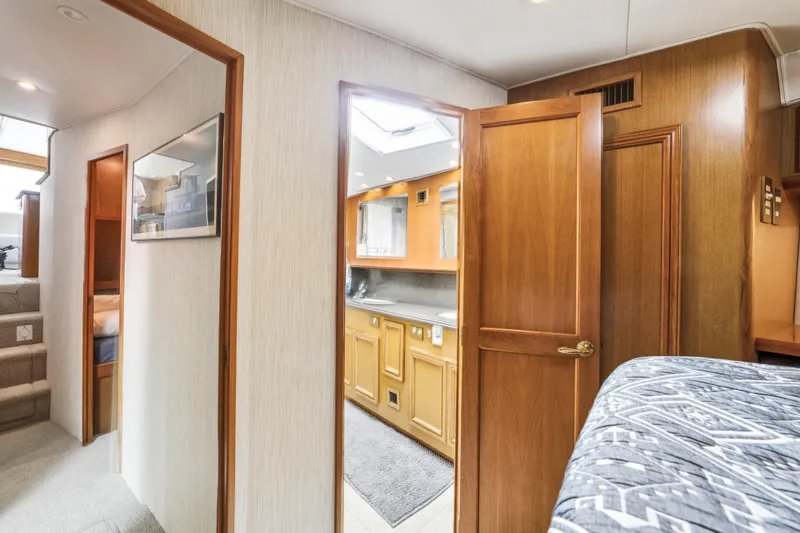 Slide: The Image of Interior of 2002 Cavileer 48 Flybridge Sportfish with wood finishes and cozy design. - 14