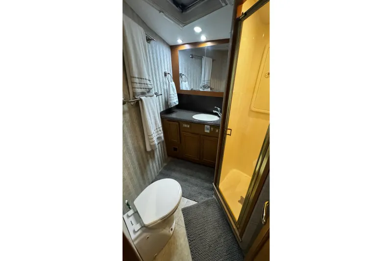 Slide: The Image of Bathroom interior of 2002 Cavileer 48 Flybridge Sportfish with shower, sink, and toilet. - 20